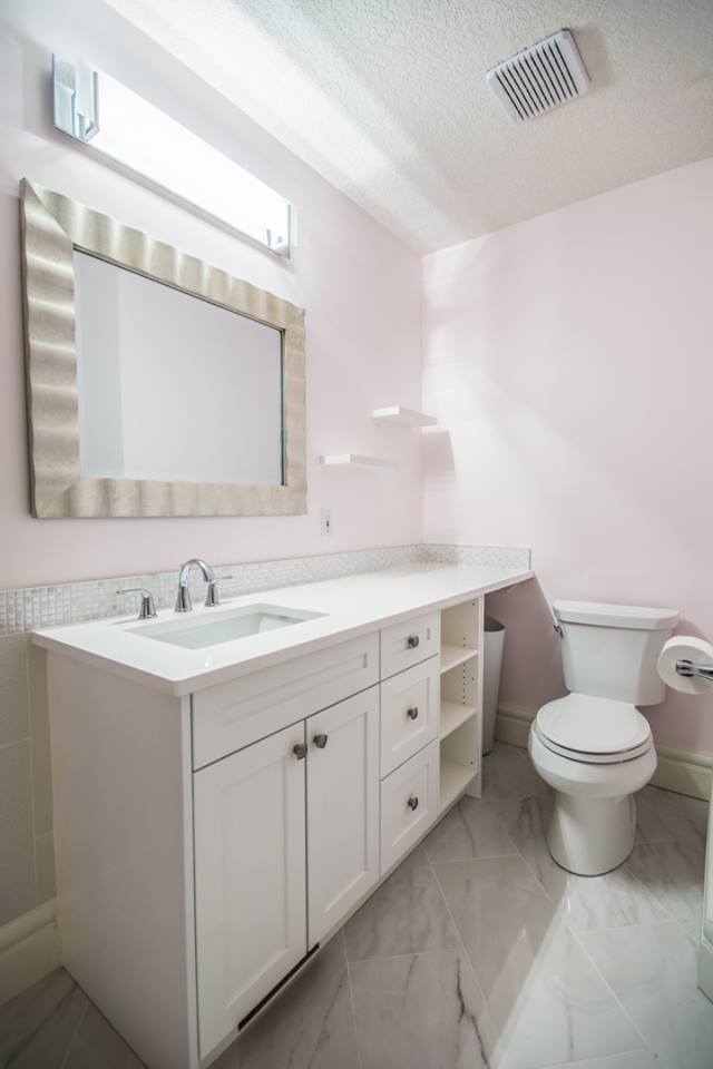 Pink bathroom with white vanity